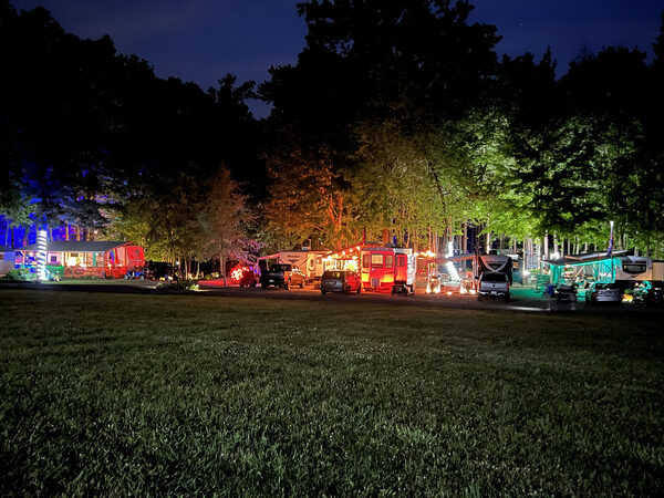 Row of seasonal camp sites lit up at night